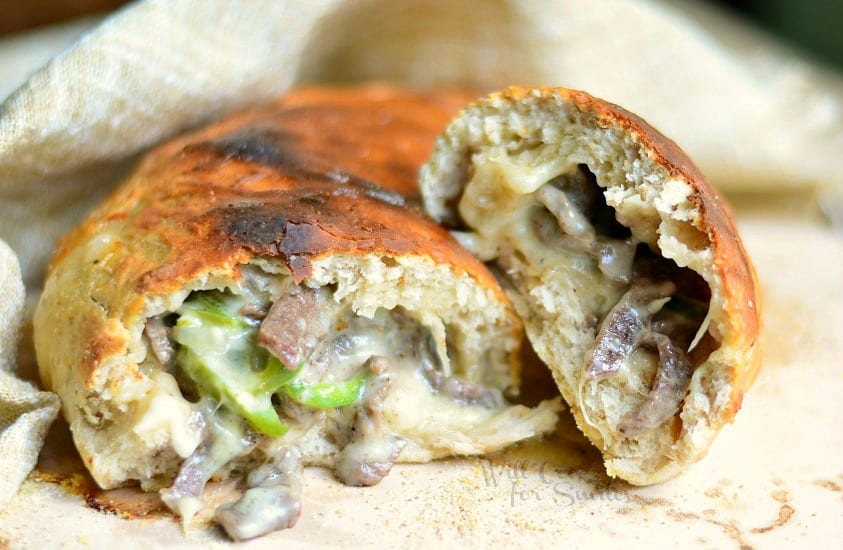 Easy Philly Cheese Steak Calzone cut in half on a tan napkin 