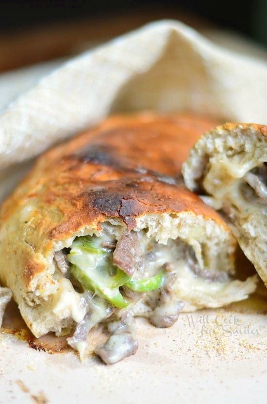 Easy Philly Cheese Steak Calzone cut in half on a tan napkin 