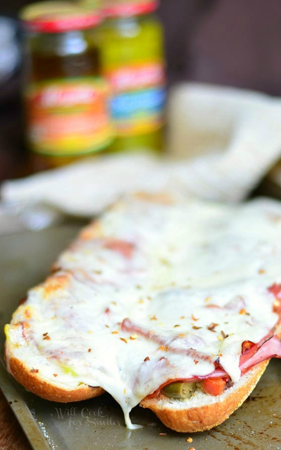 Spicy Baked Italian Sub on a baking sheet with cheese melted over it 