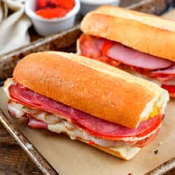 baked Italian sub sandwiches on a baking sheet.