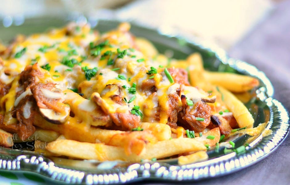 horizonal photo of Pulled BBQ Pork Loaded Fries on a silver platter 