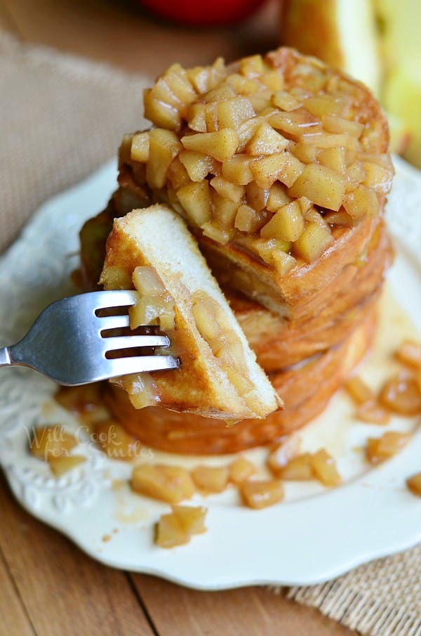 Apple Pie Stuffed French Toast on a plate with a fork with a piece on it 