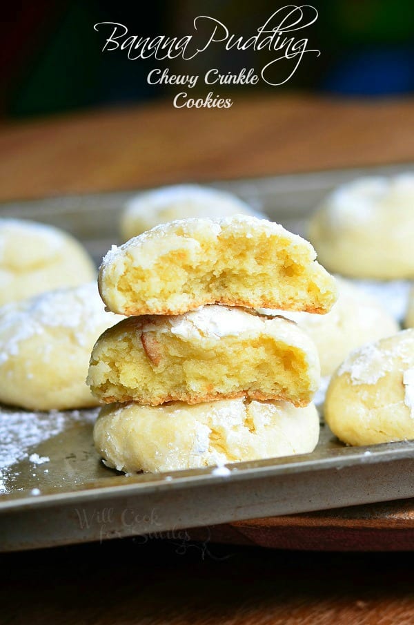 Banana Pudding Chewy Crinkle Cookies stacked up on a cookie sheet 