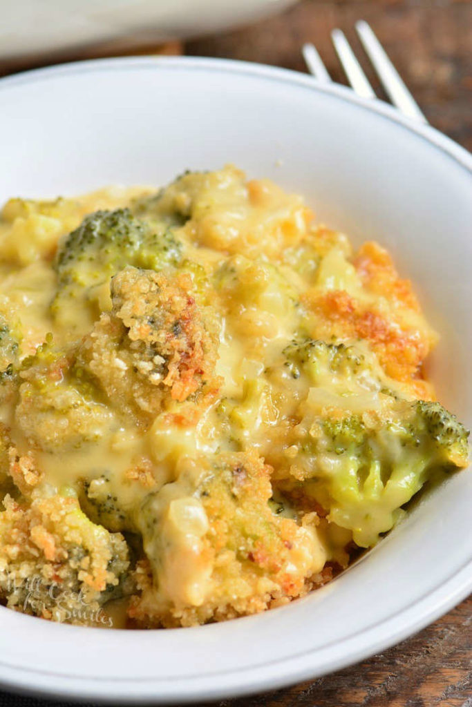 closeup top view of cheesy broccoli dish in the white bowl.