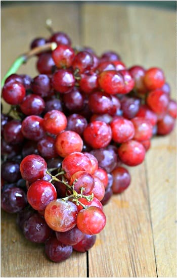 red grapes on a wood table 