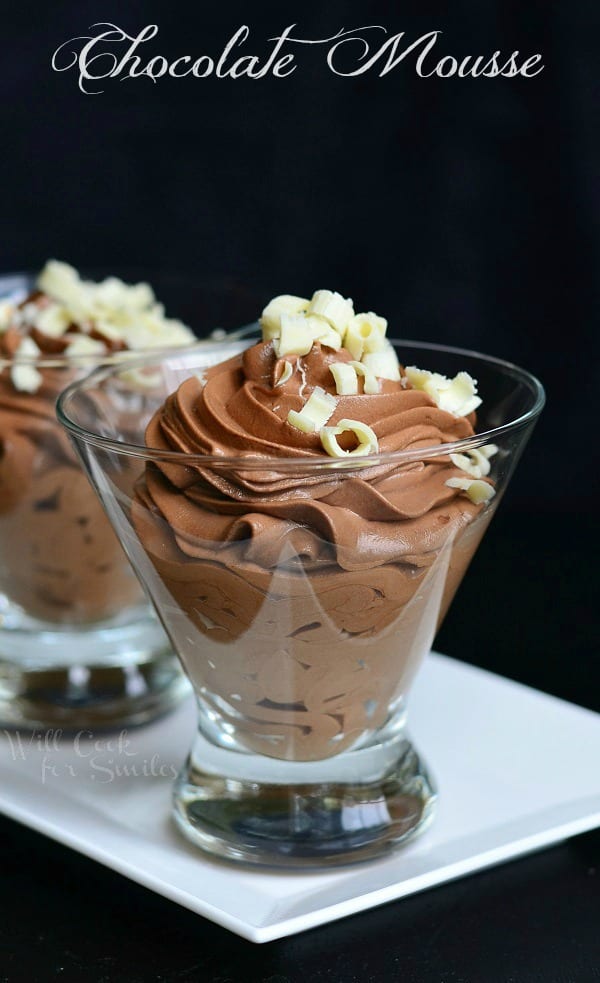 Chocolate Mousse in a glass with white chocolate shavings on top on a white tray 