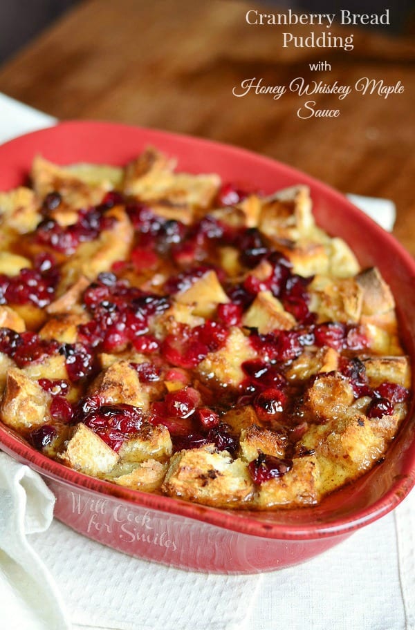 Cranberry Bread Pudding with Honey Whiskey Maple Sauce in a baking dish 