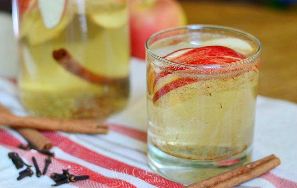 Spiced Apple Sangria in a glass with cinnamon sticks 