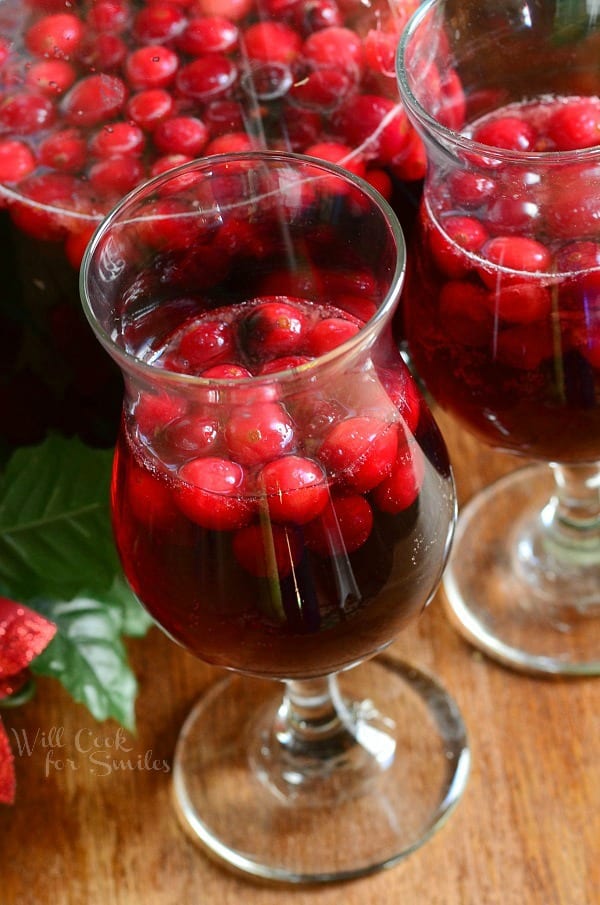Cranberry Sangria in a pitcher glasses with sangria and cranberries 