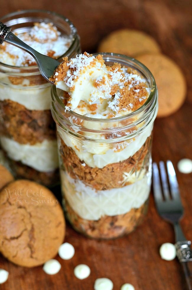 Cheesecake Gingerbread Trifles in mason jars with a fork lifting a bit out 