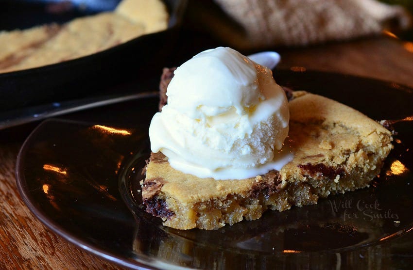 Skillet Cookie on a plate with vanilla ice cream on top 