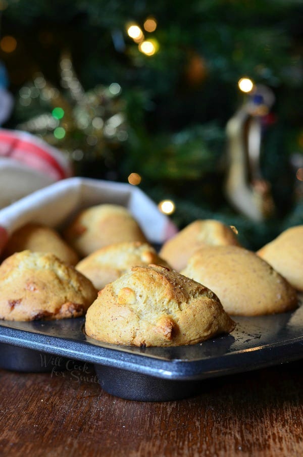 White Chocolate Chip Eggnog Muffins in a muffin tin on a table 