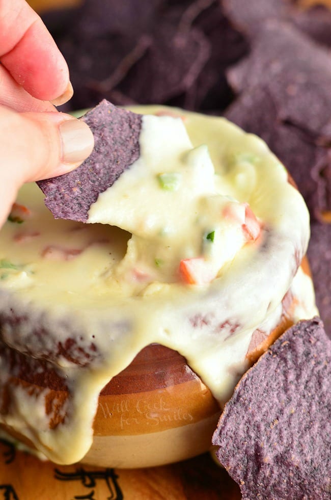bowl over-flowering with the cheesy dip and tortilla chips