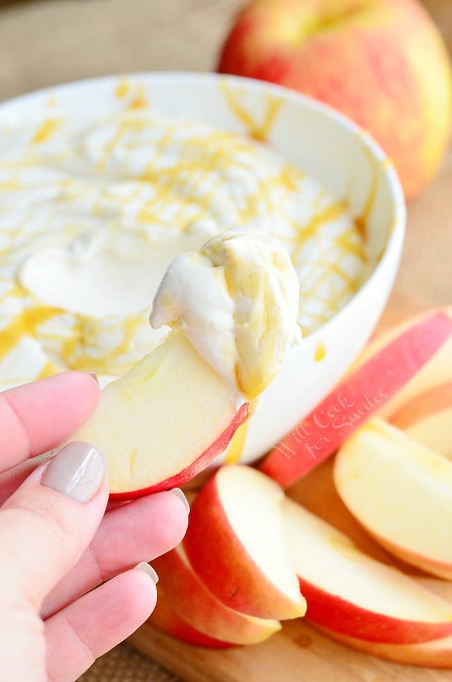 Caramel Cheesecake Fruit Dip. Light cream cheese, caramel creamer, fat free yogurt, and light caramel are all whipped to a delicate and smooth perfection making this dip out-of-this-world. #dip #dessert #fruitdip #creamcheese #caramel #skinny