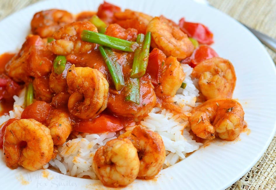 Cajun Shrimp over Rice on a plate with green onions on top