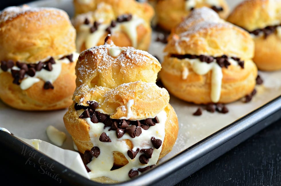 Cannoli Choux Pastry (Cream Puffs) with chocolate chips in the middle on a baking sheet 