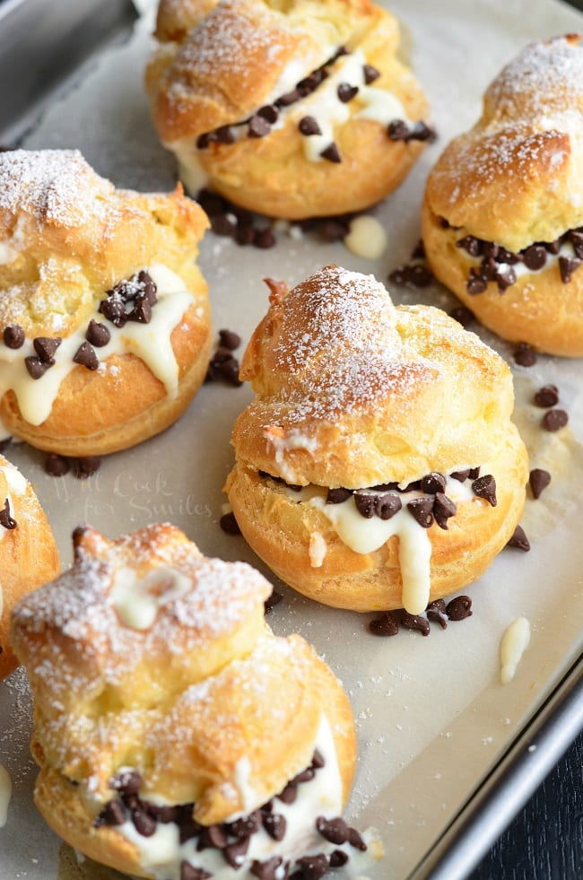 top view photo of Cannoli Choux Pastry (Cream Puffs) with chocolate chips in the middle on a baking sheet 