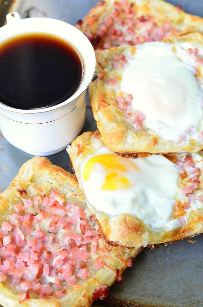 Ham, Egg & Cheese Breakfast Pastry with a cup of coffee in a white mug to the left 