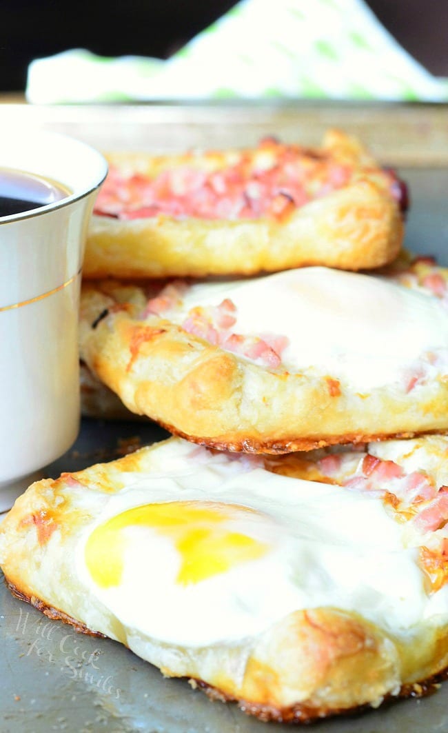 Ham, Egg & Cheese Breakfast Pastry on a baking dish with a cup of coffee