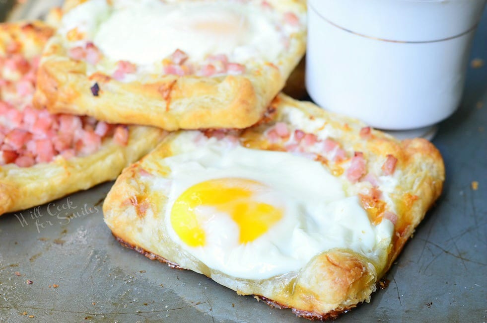 Ham, Egg & Cheese Breakfast Pastry on a baking dish with a cup of coffee