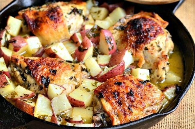 baked chicken thighs and potatoes in the skillet horizontal view