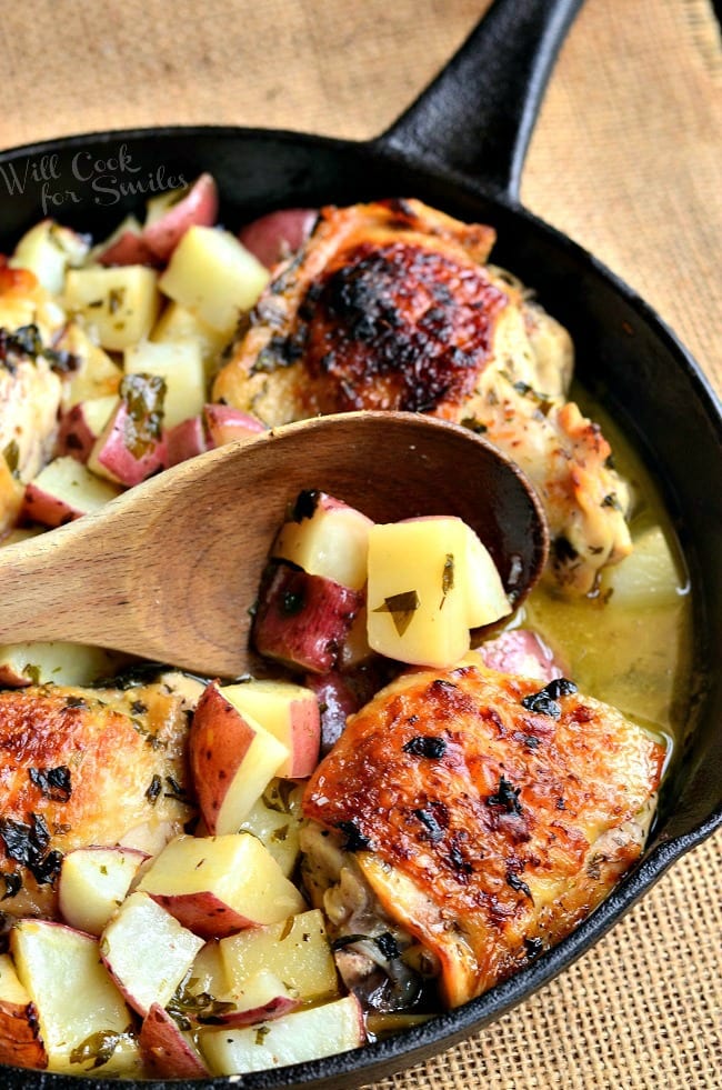 scooping potatoes with a wooden spoon