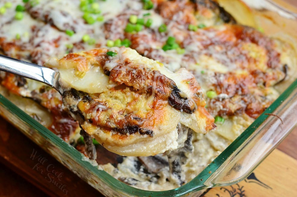 Portobello Scalloped Potatoes Au Gratin being lifted out with a metal spoon 