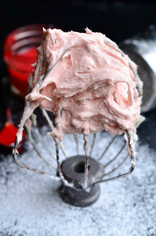 Strawberry Buttercream Frosting on a mixer whisk 