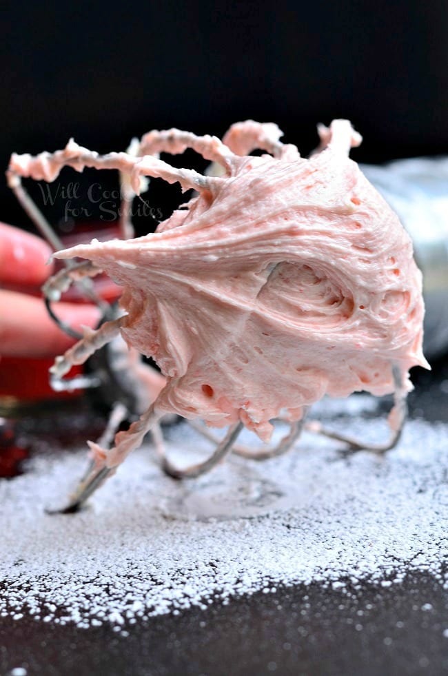 Strawberry Buttercream Frosting on a mixer whisk 