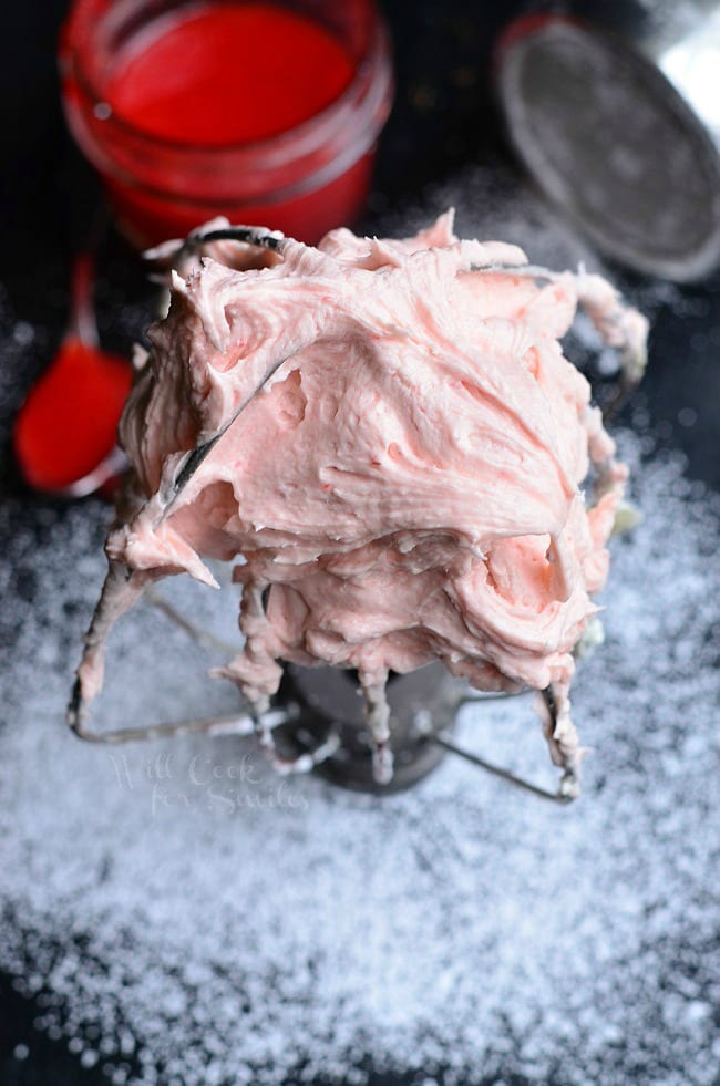 Strawberry Buttercream Frosting on a mixer whisk 