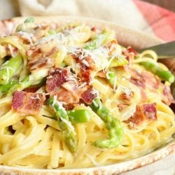 View from front of pasta dish in bowl with spoon at top right