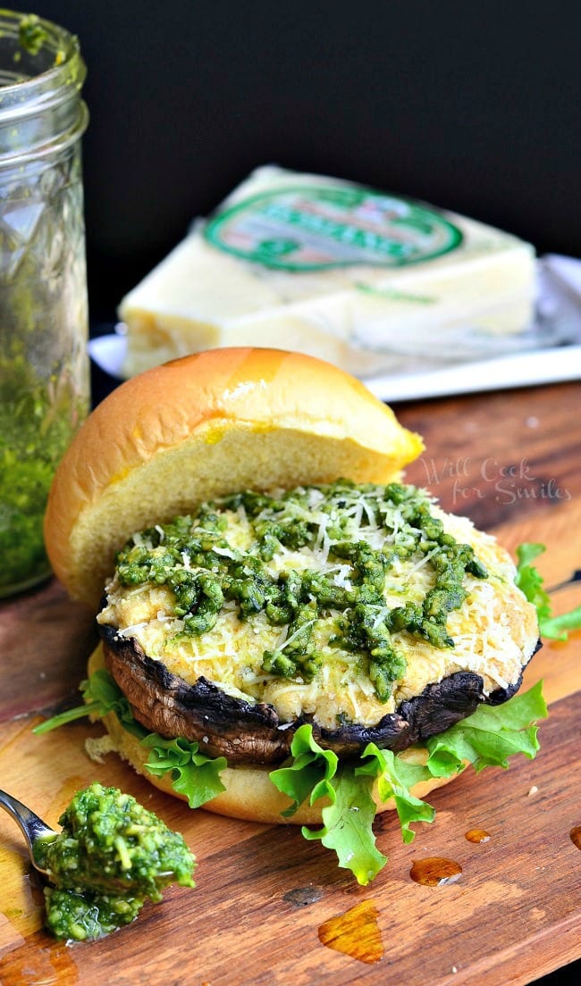 Italian Stuffed Portobello Burger on a bun with lettuce and pesto on top 