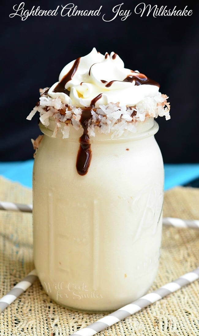 Milkshake in a mason jar with whip cream, chocolate sauce, and coconut flakes 
