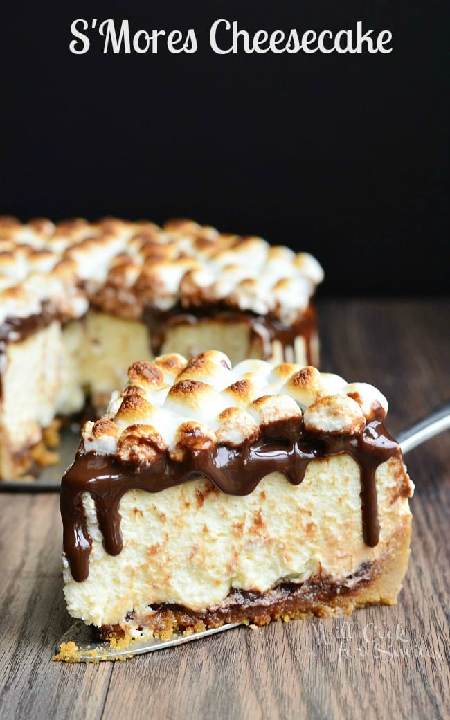 S'Mores Cheesecake with mini marshmallows on top with chocolate sauce over it 