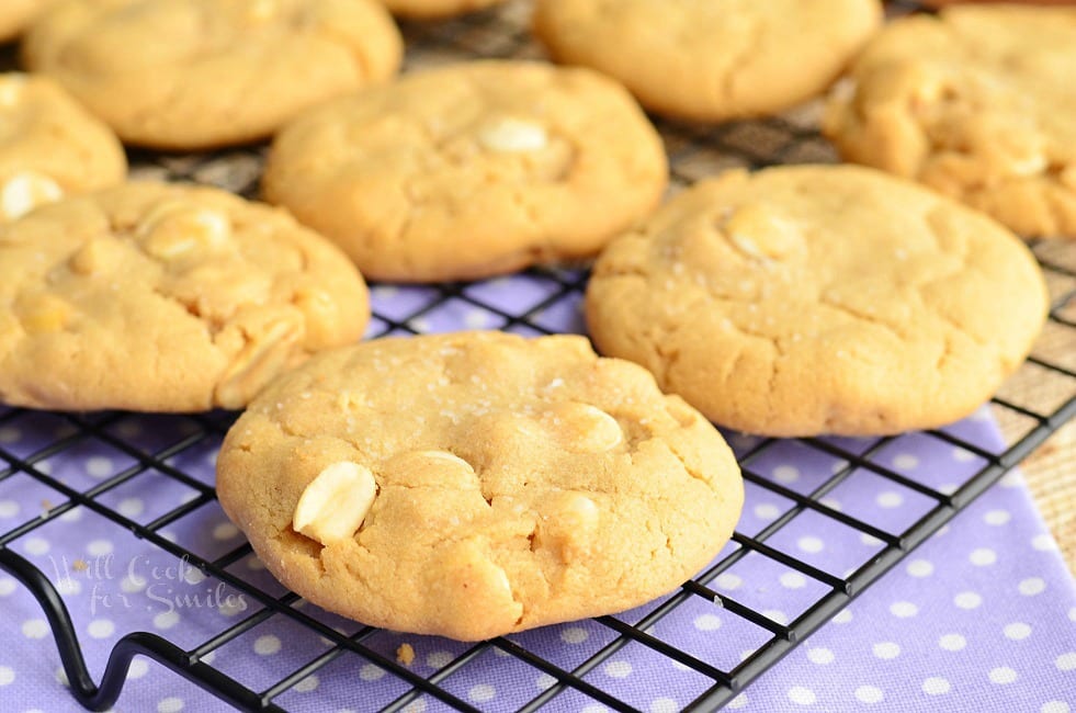 Peanut Butter White Chocolate Cookies stacked up on a napkin  on a cooling rack 