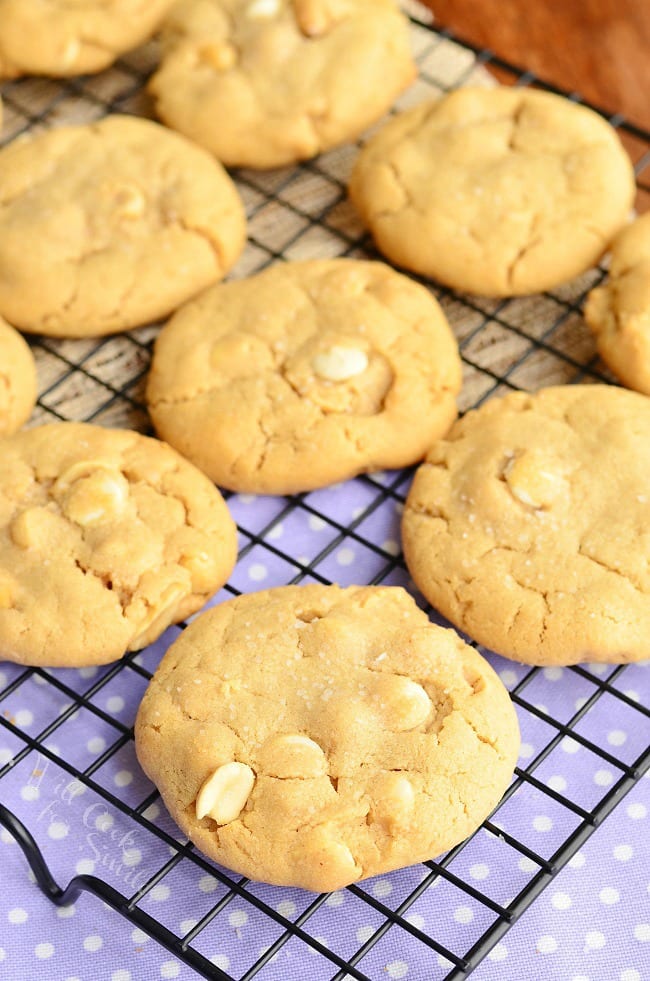 Peanut Butter White Chocolate Cookies stacked up on a napkin  on a cooling rack 