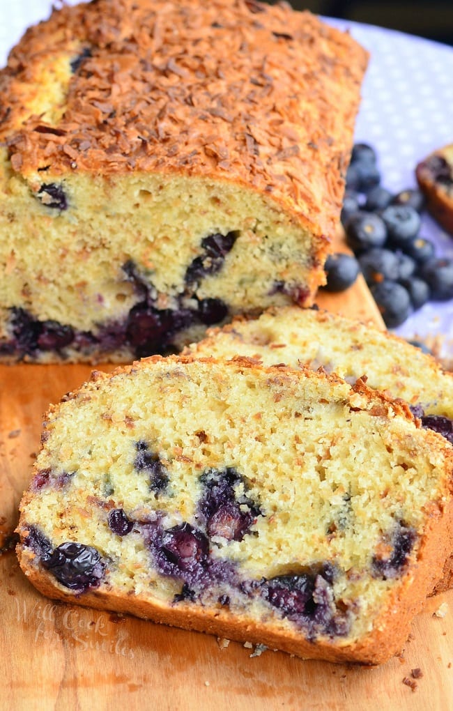 Toasted Coconut Blueberry Bread cut in slices with blueberries on the side 
