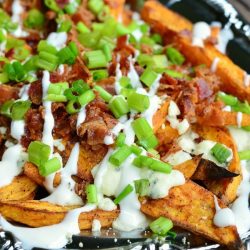 a silver platter with a side of loaded sweet potato wedges