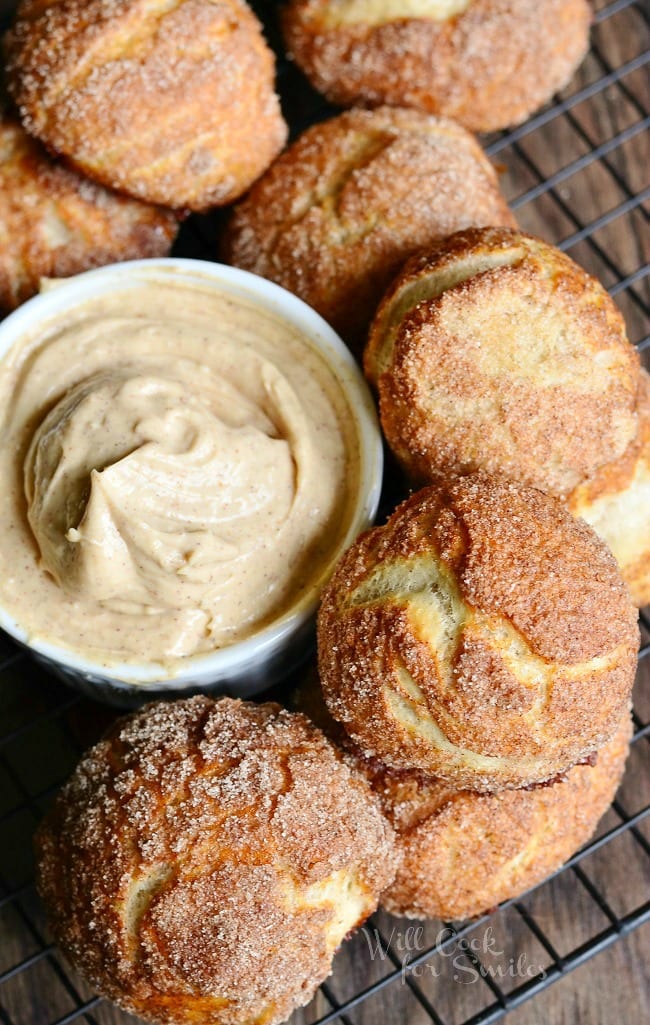 Snickerdoodle Pretzel Puffs on a cooling rack with butter in a small bowl 