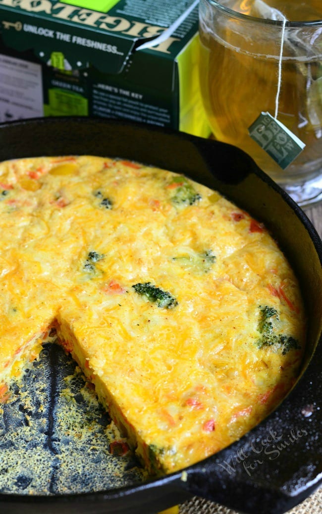 Vegetable and Cheese Breakfast Bake in a cast iron skillet with a slice missing 