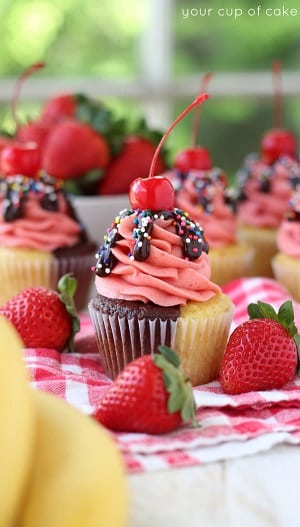 Banana split cupcakes with chocolate sauce and a cherry on top 