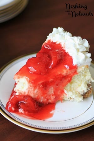 strawberry cheesecake with whipped cream and strawberry sauce on top 