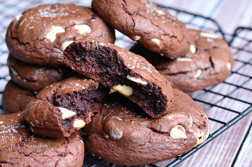 White Chocolate Brown Butter Chocolate Cookies on a cooling rack with one cookie torn in half 