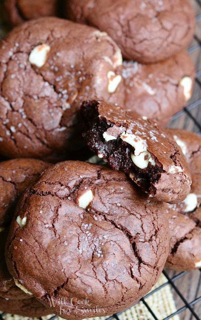 Top view White Chocolate Brown Butter Chocolate Cookies on a cooling rack with one cookie torn in half 