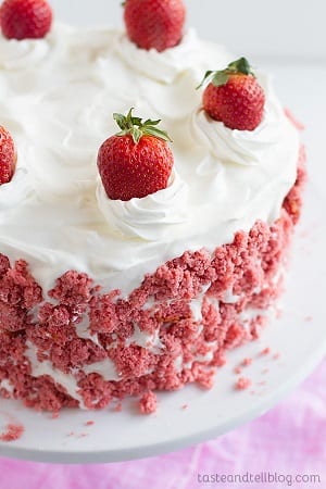 strawberry cake with white frosting and strawberries on top 