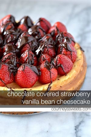 cheesecake with strawberries on top and chocolate sauce over the strawberries 