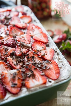 ice cream cake in a metal baking dish with chocolate and strawberries on top 