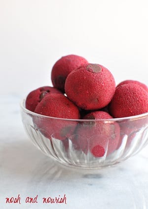 pink cookie dough balls in a clear glass bowl 