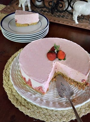 strawberry pie with a slice missing and a pie spatula 