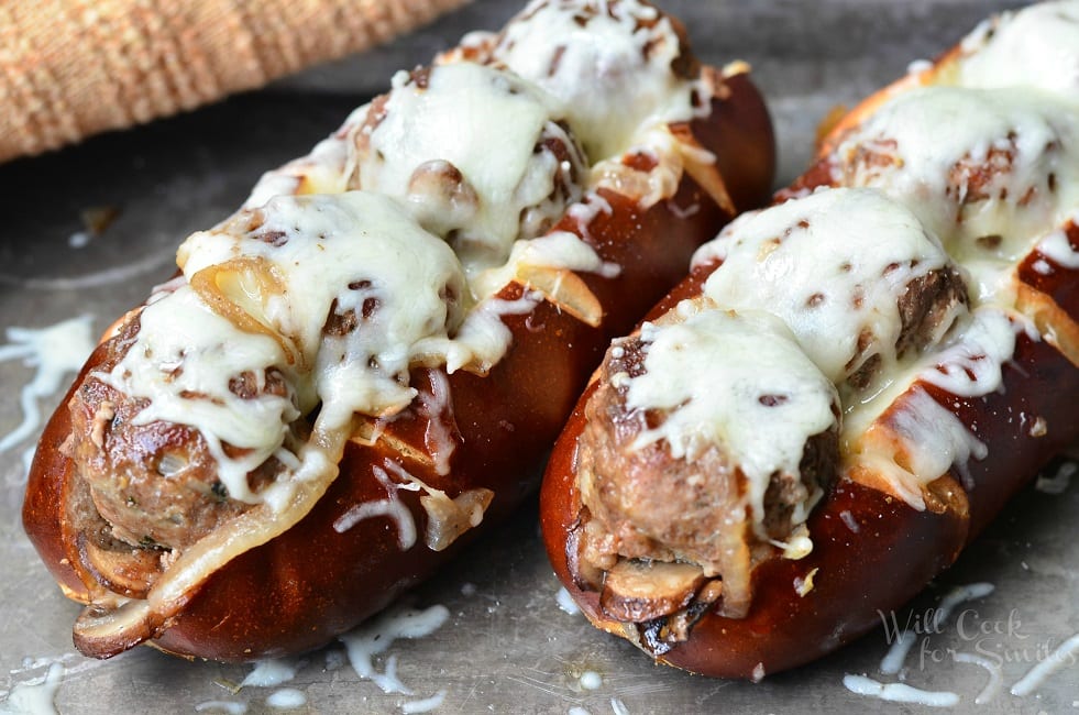 For these Bacon Buffalo Meatball Subs, juicy meatballs are lined up in a soft pretzel sub roll, baked with sauteed onions, mushrooms and bacon and topped with lots of mozzarella cheese.